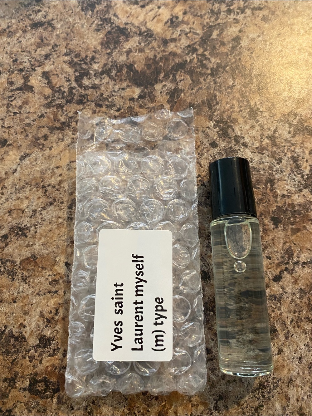Yves Saint Laurent clear roller perfume with black cap fragrant body oils